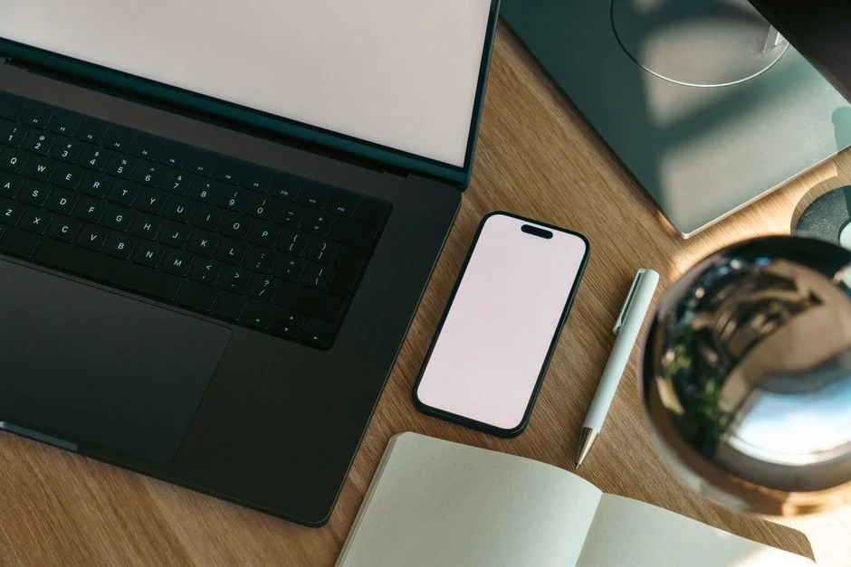 Dual monitors on a desk, showcasing web design in a modern office setting.