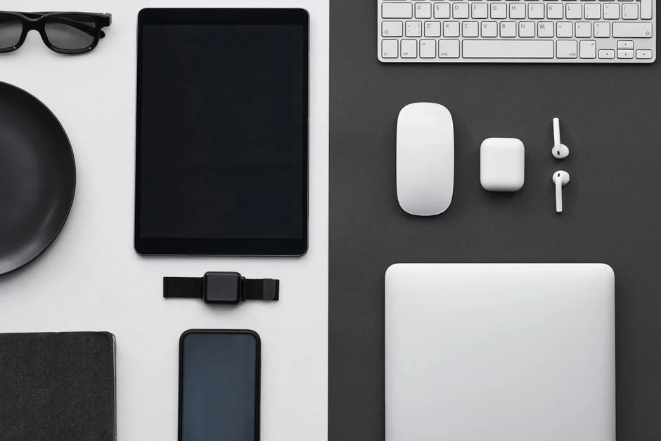 A modern work area displaying a laptop, tablet, and smartphones, perfect for tech and freelance use.